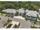 Stunning aerial view of the property showcasing a modern white exterior, a tile roof, and palm tree landscaping at 2960 Sandringham Pl, Sarasota, FL 34235