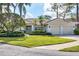 Single-Gathering house with a two-car garage and palm trees at 2960 Sandringham Pl, Sarasota, FL 34235