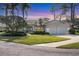 Charming single-story home featuring a well-manicured lawn and a two-car garage at 2960 Sandringham Pl, Sarasota, FL 34235