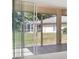 A cozy outdoor patio with screen and sliding glass doors offering an inviting outdoor living experience at 2960 Sandringham Pl, Sarasota, FL 34235