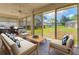 Bright sunroom featuring stylish furniture and sliding glass doors to the backyard at 2960 Sandringham Pl, Sarasota, FL 34235