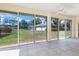 Bright sunroom with sliding glass doors offering backyard views at 2960 Sandringham Pl, Sarasota, FL 34235
