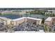 Aerial view of condo building with lake, landscaping, and large parking lot with plenty of parking spaces at 3937 Lake Bayshore Dr # 401, Bradenton, FL 34205