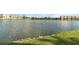 Scenic view of a large pond, grassy shoreline, and distant buildings, a tranquil natural setting at 3937 Lake Bayshore Dr # 401, Bradenton, FL 34205