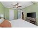 Main bedroom with large bed, wood dresser, and access to other rooms at 3948 Middlesex Pl, Sarasota, FL 34241