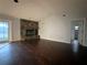 Living room features a stone fireplace and dark laminate flooring at 461 S Florida Ave, Tarpon Springs, FL 34689