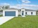 Charming single-story home with a blue garage door and lush green lawn at 4763 Andris St, North Port, FL 34288