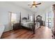 Bedroom with wood-style flooring and a four-poster bed at 4875 Wood Pointe Way, Sarasota, FL 34233