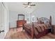 A bedroom with two windows, wooden furniture, and ample space at 4875 Wood Pointe Way, Sarasota, FL 34233
