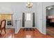 Bright foyer with hardwood floors, chandelier, and access to an office at 4875 Wood Pointe Way, Sarasota, FL 34233