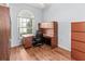 Home office with wood desk, arched window, and ample storage at 4875 Wood Pointe Way, Sarasota, FL 34233