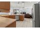 Kitchen with wood cabinets, stainless steel appliances, and view to the living room at 4875 Wood Pointe Way, Sarasota, FL 34233