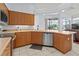 Kitchen with ample counter space, stainless steel appliances, wood cabinets, and water view at 4875 Wood Pointe Way, Sarasota, FL 34233