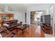 Living room with leather furniture, large windows, and a fireplace at 4875 Wood Pointe Way, Sarasota, FL 34233
