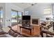 Living room with fireplace, leather furniture, and a view of the pool at 4875 Wood Pointe Way, Sarasota, FL 34233