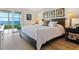 Main bedroom with water views and light wood floors at 4900 Gulf Of Mexico Dr # 205, Longboat Key, FL 34228
