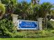 Welcome to Longboat Key sign with lush tropical landscaping at 4900 Gulf Of Mexico Dr # 205, Longboat Key, FL 34228