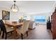 Elegant dining area with hardwood floors and water views at 4900 Gulf Of Mexico Dr # 205, Longboat Key, FL 34228