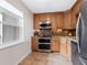 Modern kitchen with wood cabinets, granite countertops, and stainless steel appliances at 4900 Gulf Of Mexico Dr # 205, Longboat Key, FL 34228