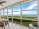 Bright sunroom with stunning water views and comfortable seating at 4900 Gulf Of Mexico Dr # 205, Longboat Key, FL 34228