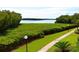 Peaceful waterfront view with lush landscaping and a walkway at 4900 Gulf Of Mexico Dr # 205, Longboat Key, FL 34228