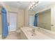 Practical bathroom with blue curtains and large mirror at 5024 Southern Pine Cir, Venice, FL 34293