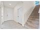 Beige carpeted staircase with a simple white railing at 5316 Rocky Coast Place, Palmetto, FL 34221