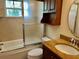 Bathroom featuring updated vanity, tub with shower, and frosted glass shower door at 5405 Fair Oaks St # 5405, Bradenton, FL 34203