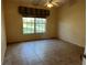 Bedroom with tile flooring, neutral walls, and a large window with green outdoor view at 5405 Fair Oaks St # 5405, Bradenton, FL 34203