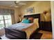 Well-lit main bedroom with a ceiling fan, neutral walls, and large window with curtains at 5405 Fair Oaks St # 5405, Bradenton, FL 34203