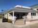 A community clubhouse exterior with a patio featuring a table and seating at 5405 Fair Oaks St # 5405, Bradenton, FL 34203