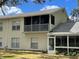Two-story home with a screened in porch and a view of the backyard at 5405 Fair Oaks St # 5405, Bradenton, FL 34203