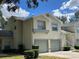 Charming townhouse featuring a two-car garage and well-maintained landscaping under a bright blue sky at 5405 Fair Oaks St # 5405, Bradenton, FL 34203