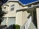 Two-story townhouse with attached garage, front entrance stairs, and a well-maintained lawn at 5405 Fair Oaks St # 5405, Bradenton, FL 34203