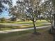 Golf course with mature trees and sand traps with homes in the distance at 5405 Fair Oaks St # 5405, Bradenton, FL 34203