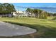 Beautiful golf course view with lush green grass, sand traps, and homes in the background at 5405 Fair Oaks St # 5405, Bradenton, FL 34203