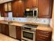 Well-equipped kitchen featuring stainless steel appliances, granite countertops, and stylish backsplash, offering a modern touch at 5405 Fair Oaks St # 5405, Bradenton, FL 34203