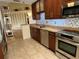 Well-equipped kitchen featuring stainless steel appliances, granite countertops, and stylish backsplash, with open access to other areas at 5405 Fair Oaks St # 5405, Bradenton, FL 34203