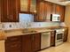 Beautiful kitchen with stainless steel appliances, stylish backsplash, granite countertops, and ample cabinet space at 5405 Fair Oaks St # 5405, Bradenton, FL 34203