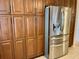 This kitchen features wood cabinets and a stainless steel refrigerator at 5405 Fair Oaks St # 5405, Bradenton, FL 34203