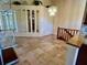 Open living area featuring ceramic tile flooring, mirrored wall accents and staircase at 5405 Fair Oaks St # 5405, Bradenton, FL 34203