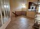 Open living area with staircase, tile flooring, and decorative chandelier at 5405 Fair Oaks St # 5405, Bradenton, FL 34203