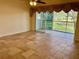Living room featuring neutral walls, tile flooring, and sliding doors to enclosed patio at 5405 Fair Oaks St # 5405, Bradenton, FL 34203