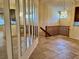 Open living area featuring ceramic tile flooring, mirrored wall accents and staircase at 5405 Fair Oaks St # 5405, Bradenton, FL 34203