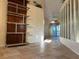 Bright and airy living room with tile flooring, neutral walls, and a modern shelving unit, creating a welcoming atmosphere at 5405 Fair Oaks St # 5405, Bradenton, FL 34203