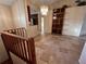 Open-concept living area with tile flooring, a shelving unit, and a staircase, bathed in natural light at 5405 Fair Oaks St # 5405, Bradenton, FL 34203