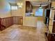Living room featuring staircase, chandelier, tile flooring, and an adjacent modern kitchen at 5405 Fair Oaks St # 5405, Bradenton, FL 34203