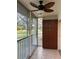 Enclosed back patio includes a ceiling fan, tiled floor, and extra cabinet storage at 5405 Fair Oaks St # 5405, Bradenton, FL 34203