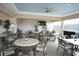 Spacious outdoor patio with seating, ceiling fan, lighting, and a television at 5405 Fair Oaks St # 5405, Bradenton, FL 34203