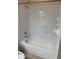 Bathroom with shower/tub combo, toilet, and tiled walls at 5467 Soapstone Pl # 203, Sarasota, FL 34233